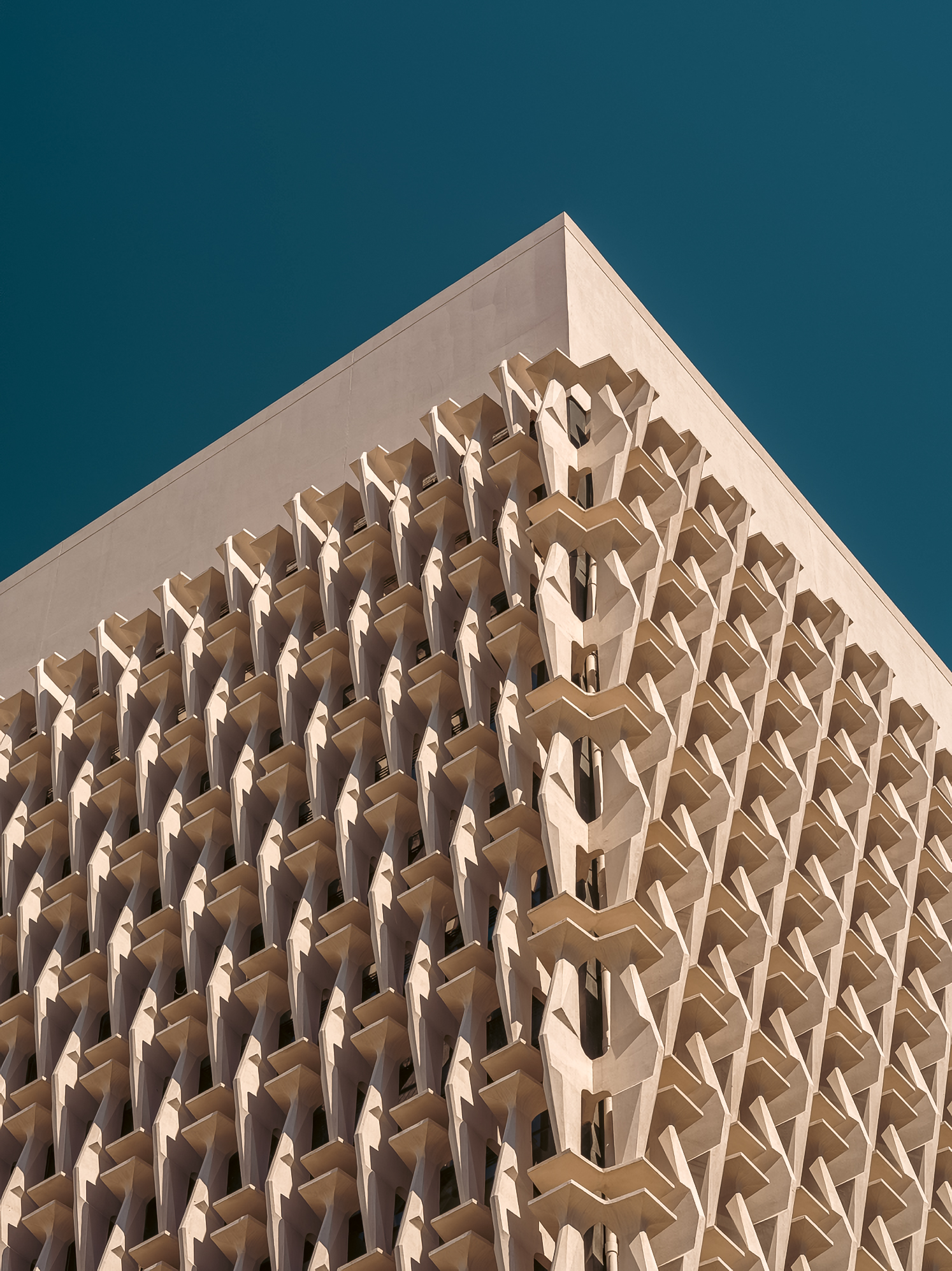 The geometric lattice façade at the corner of a modern building