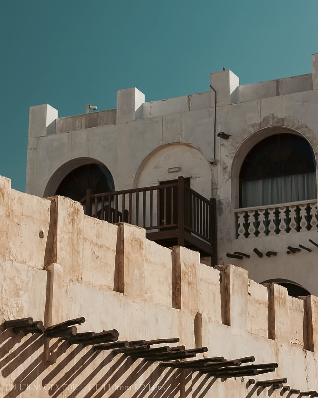 A traditional Kuwaiti facade above an old boundary wall