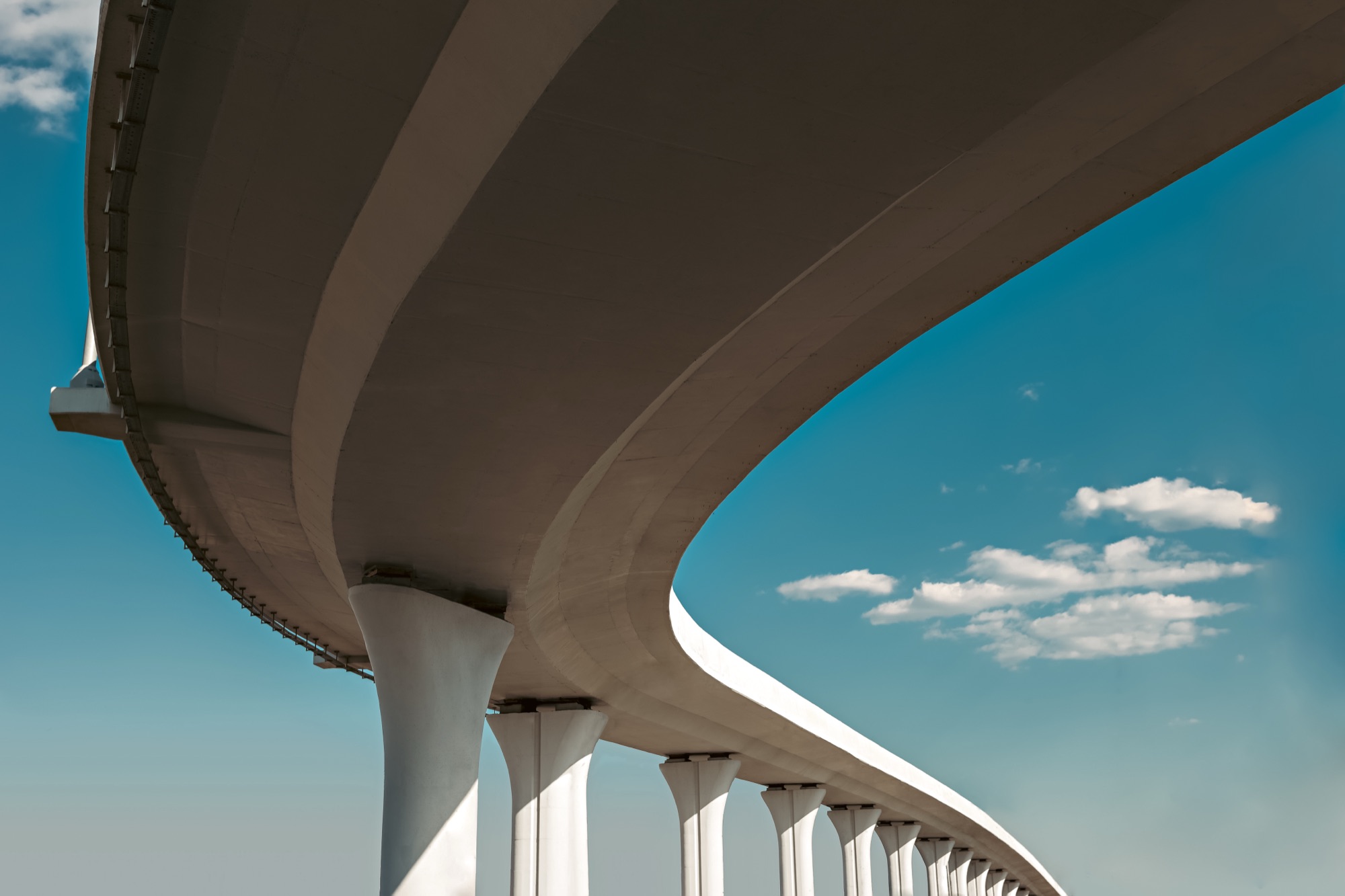 A curved modern viaduct against a clear sky